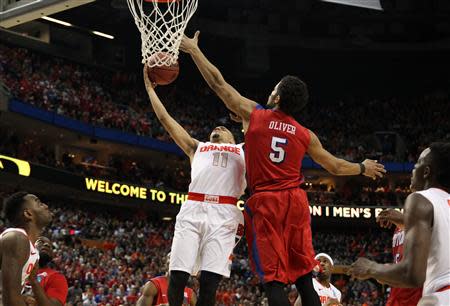 Mar 22, 2014; Buffalo, NY, USA; Syracuse Orange guard Tyler Ennis (11) misses a shot late as Dayton Flyers forward Devin Oliver (5) defends in the second half of a men's college basketball game during the third round of the 2014 NCAA Tournament at First Niagara Center. Timothy T. Ludwig-USA TODAY Sports