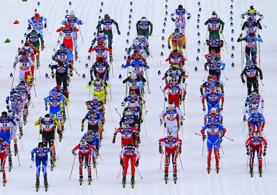 Competitors race at the start of the women's skiathlon competition at the Nordic World Ski Championships in the northern mountain resort of Tesero in Val di Fiemme February 23, 2013. REUTERS/Yves Herman (ITALY - Tags: SPORT SKIING TPX IMAGES OF THE DAY) - RTR3E5RM