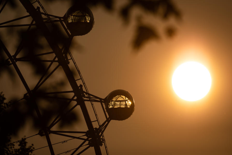 The sun rises behind the London Eye ferris wheel, London, at the start of a week in which the UK is expected to bask in temperatures of more than 30C.