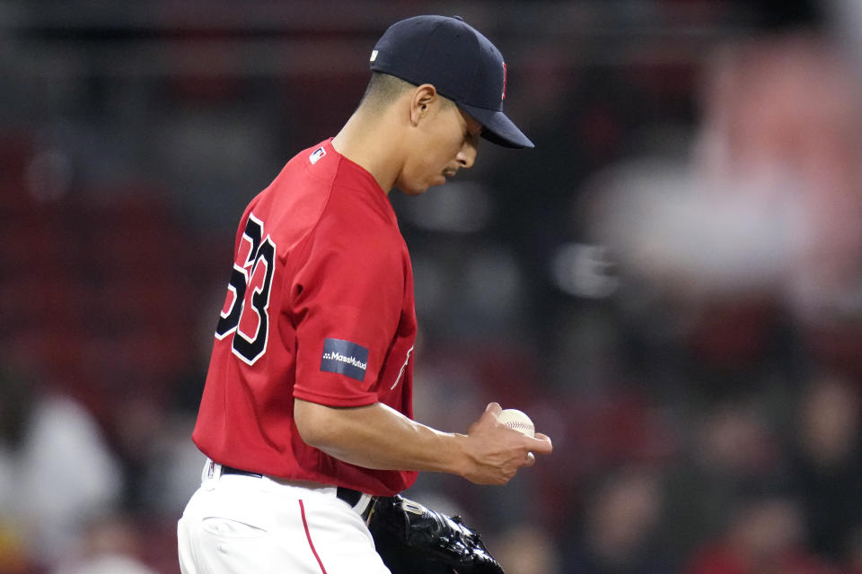 Boston Red Sox pitcher Justin Garza looks down at the ball in the tenth inning during a baseball game against the Colorado Rockies at Fenway Park, Tuesday, June 13, 2023, in Boston. (AP Photo/Charles Krupa)