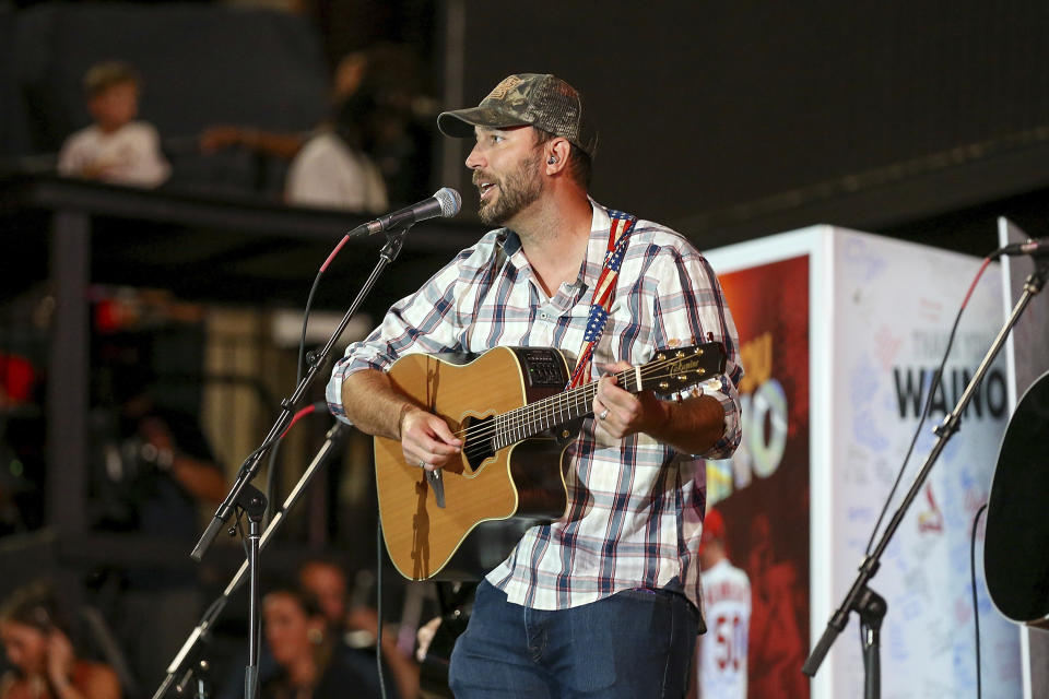 St. Louis Cardinals' Adam Wainwright performs a short concert for fans after the team's baseball game against the Cincinnati Reds on Saturday, Sept. 30, 2023, in St. Louis. (AP Photo/Scott Kane)