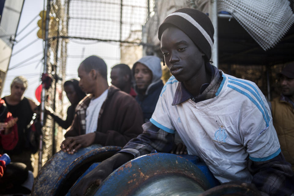 In this photo taken on Saturday, Nov. 24, 2018 photo, Migrants rest aboard Nuestra Madre de Loreto, a Spanish fishing vessel that rescued twelve migrants two days ago about 78 miles north off Libyan shore. The Spanish NGO Proactiva Open Arms assisted the migrants aboard the fishing vessel medically and provided them with food, blankets and clothes. (AP Photo/Javier Fergo)