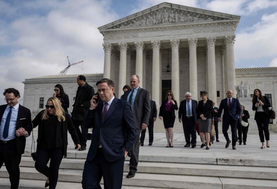 People leave the Supreme Court after the first hearing for student debt cancellation in Washington, DC, on February 28, 2023.