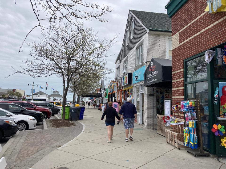 People walk along Rehoboth Avenue on Monday, May 23, 2022.