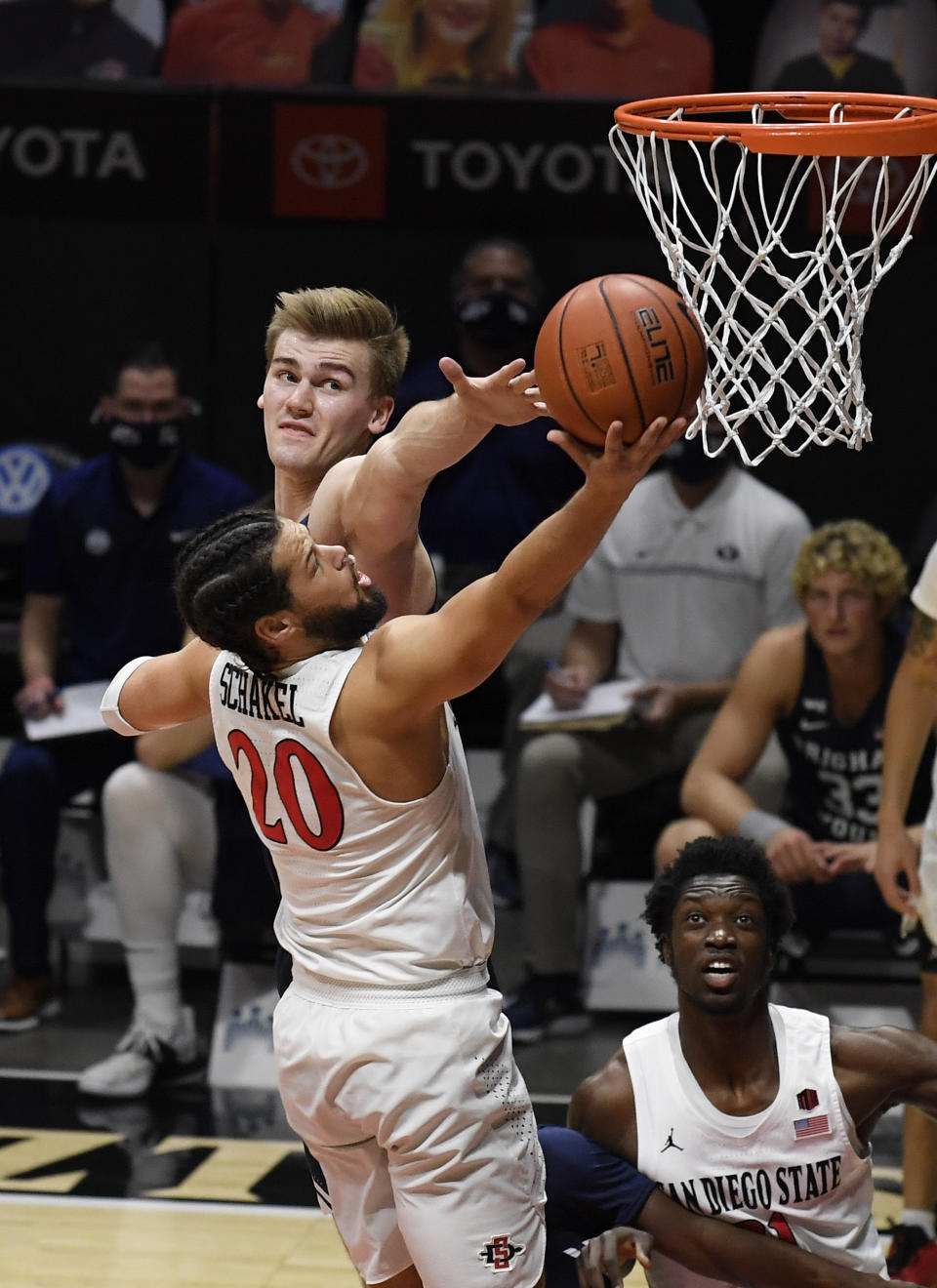 San Diego State guard Jordan Schakel (20) shoots over BYU forward Matt Haarms (3) during the first half of an NCAA college basketball game Friday, Dec. 18, 2020, in San Diego. (AP Photo/Denis Poroy)