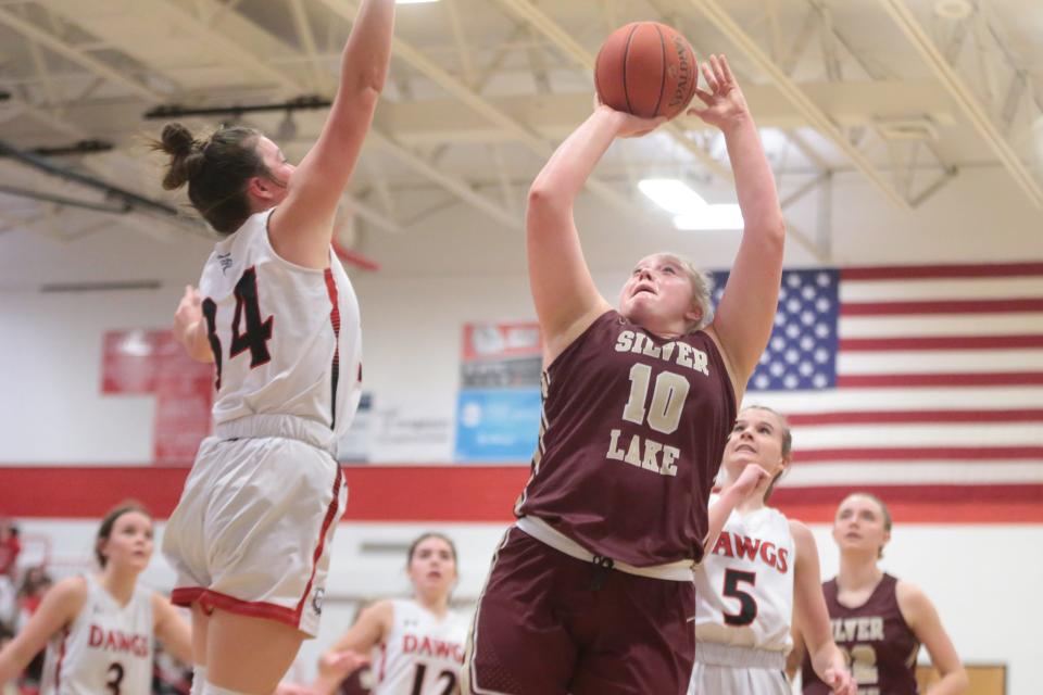 Silver Lake junior MaKenzie McDaniel (10) shoots under the basket during the third quarter of Tuesday's War on 24 game against Rossville.