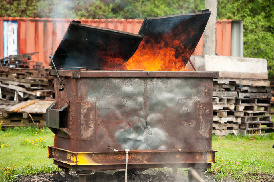 A burning dumpster fire, as part of a fire fighter's training exercise. Squamish BC, Canada. April 29, 2018.