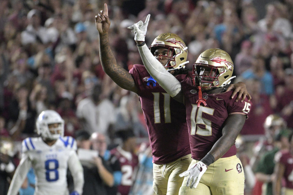 Florida State linebacker Tatum Bethune (15) and defensive lineman Patrick Payton (11) celebrate after Bethune made a tackle for a loss during the second half of an NCAA college football game against Duke, Saturday, Oct. 21, 2023, in Tallahassee, Fla. (AP Photo/Phelan M. Ebenhack)