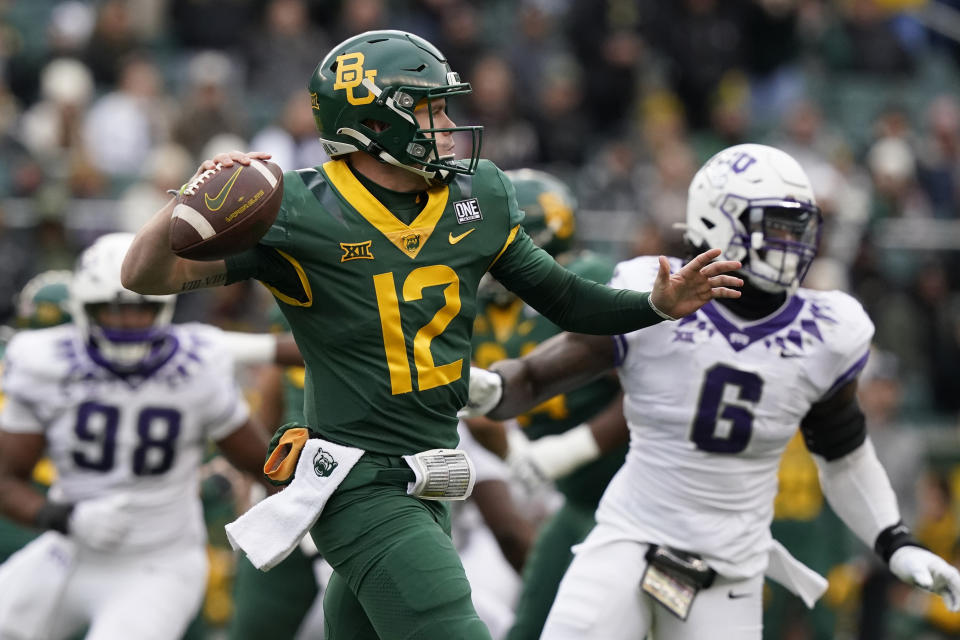 Baylor quarterback Blake Shapen (12) passes in front of TCU defenders Jamoi Hodge (6) and Dylan Horton (98) during the first half of an NCAA college football game in Waco, Texas, Saturday, Nov. 19, 2022. (AP Photo/LM Otero)