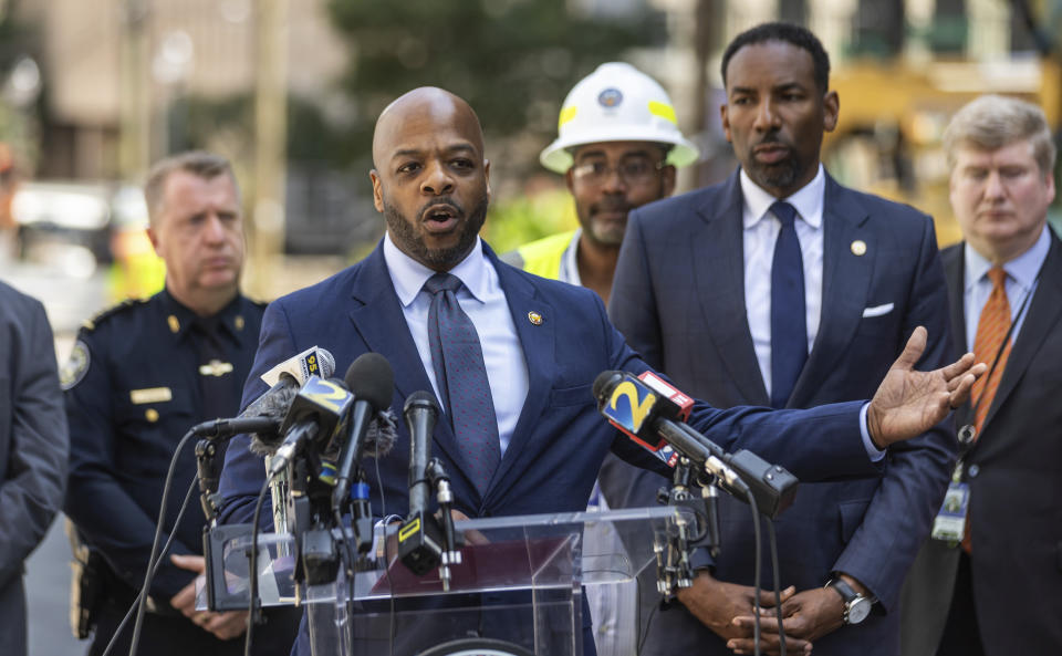 Watershed Commissioner Al Wiggins speaks at a news conference alongside Atlanta Mayor Andre Dickens, Monday, June 3, 2024, in Atlanta. A water outage shut down businesses and left faucets dry at many homes in the area. City officials say water was shut down as part of a successful effort to stanch the flow from a broken water main. It had been gushing a river into the streets since Friday night. (John Spink/Atlanta Journal-Constitution via AP)