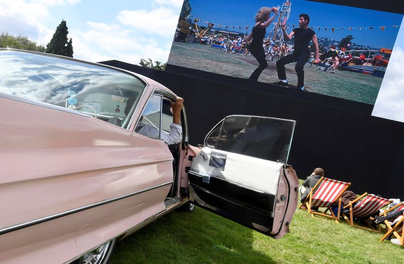 FILE PHOTO: Motoring enthusiasts attend the Goodwood Revival, a three day classic car racing festival celebrating the mid-twentieth century heyday of the sport, at Goodwood in southern Britain