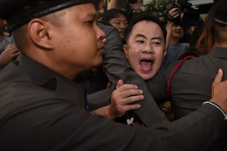 A protester shouts slogan as police officers block him during a protest against junta near Democracy monument in Bangkok, Thailand, March 24, 2018. REUTERS/Panumas Sanguanwong