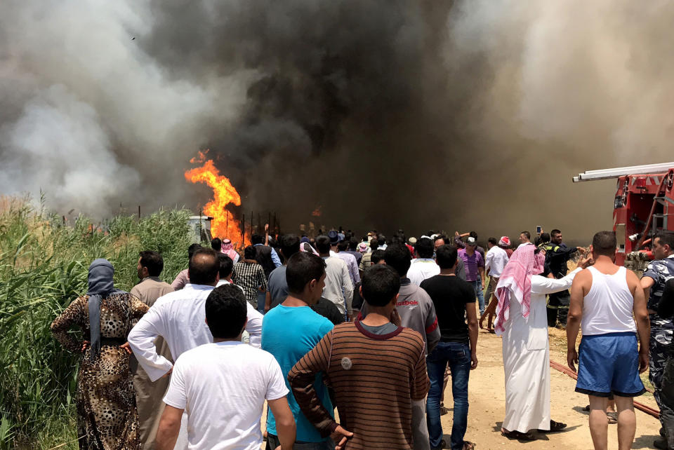 <p>Smoke rises after fire breaks out due to an unknown reason at the Qob Elias refugee camp at the Beqaa valley in Lebanon on July 1, 2017. (Hasan Jarrah/Anadolu Agency/Getty Images) </p>