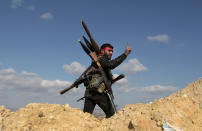 <p>A pro-Turkey Syrian fighter waves on Bursayah hill, which separates the Kurdish-held enclave of Afrin from the Turkey-controlled town of Azaz, Syria, Jan. 28, 2018. Syria’s Kurdish militia is growing frustrated with its patron, the United States, and is pressing it to do more to stop Turkeyâs assault on Afrin. Their complaints reflect the differing agendas. The Kurds want to ensure their self-rule, while the U.S. wants them to focus on governing the territory they wrested from IS militants. (Photo: AP) </p>