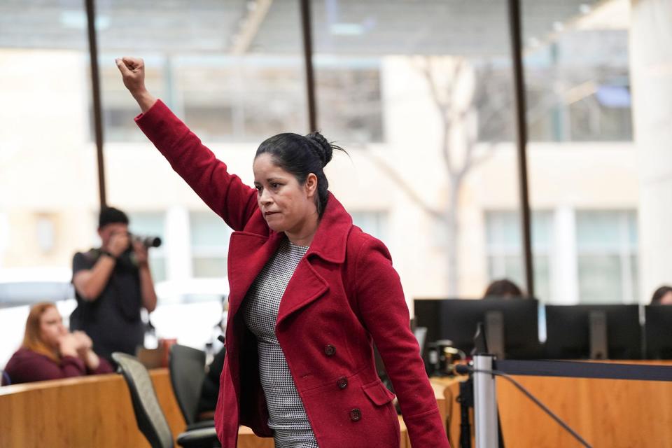 Linda Nuno raises a fist after speaking during the City Council meeting Wednesday. Nuno called for firing City Manager Spencer Cronk, who had been the focus of criticism in the wake of weather-related power outages earlier this month.