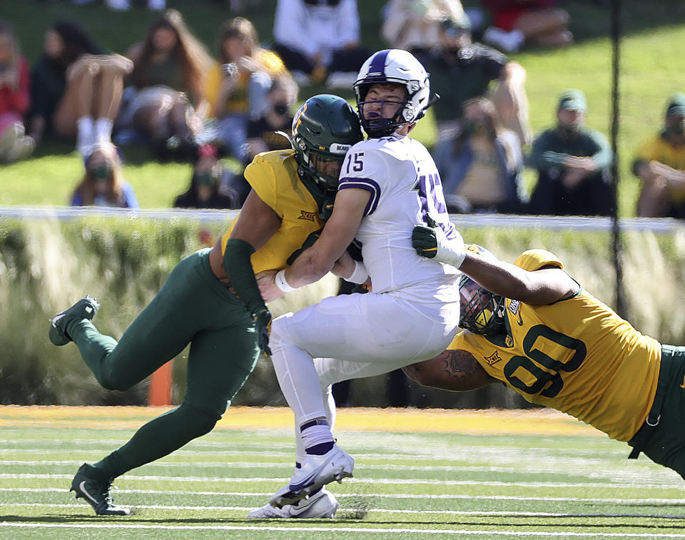 TCU quarterback Max Duggan (15) is hit on the helmet by Baylor safety Jalen Pitre, left, who was ejected for targeting during the first half of an NCAA college football game in Waco, Texas, Saturday, Oct. 31, 2020. (Jerry Larson/Waco Tribune-Herald via AP)