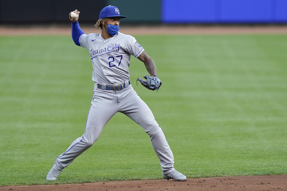 Kansas City Royals shortstop Adalberto Mondesi (27) throws the ball to first base for an out during the first inning of a baseball game against the Cincinnati Reds at Great American Ballpark in Cincinnati, Tuesday, August 11, 2020. (AP Photo/Bryan Woolston)