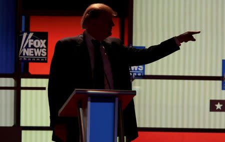 Republican U.S. presidential candidate Donald Trump points at rival candidate Ted Cruz (not pictured) during a break at the U.S. Republican presidential candidates debate in Detroit, Michigan, March 3, 2016. REUTERS/Rebecca Cook