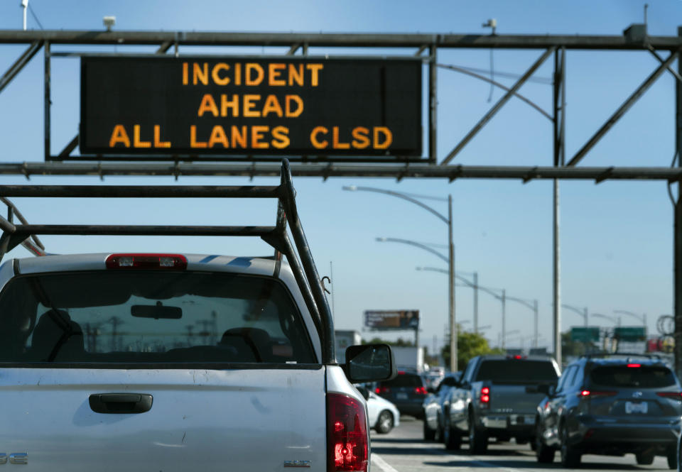 Traffic backed up along a closed Interstate 10 after a fire that severely damaged the freeway in downtown Los Angeles on Saturday, Nov. 11, 2023. Authorities say firefighters have mostly extinguished a large blaze that burned trailers, cars and other things in storage lots beneath a major highway near downtown Los Angeles, forcing the temporary closure of the roadway. (AP Photo/Richard Vogel)