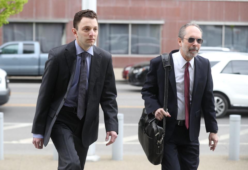 Todd Morgan enters  federal court in Buffalo with his attorney David Rothenberg before being charged with fraud. 