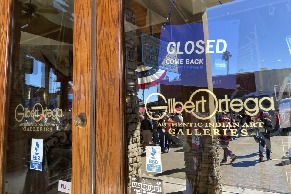 Gilbert Ortega's Authentic Indian Art Galleries in Scottsdale, Ariz., is seen closed on Friday, Feb. 10, 2023. Native American dancers who were the target of a suburban Phoenix gallery owner's racist rant as they were being filmed for Super Bowl week are pushing for hate crime charges. Gilbert Ortega Jr., the owner of Gilbert Ortega Native American Galleries, has been charged with three misdemeanor counts of disorderly conduct regarding the incident, Scottsdale police said. (AP Photo/Alina Hartounian)