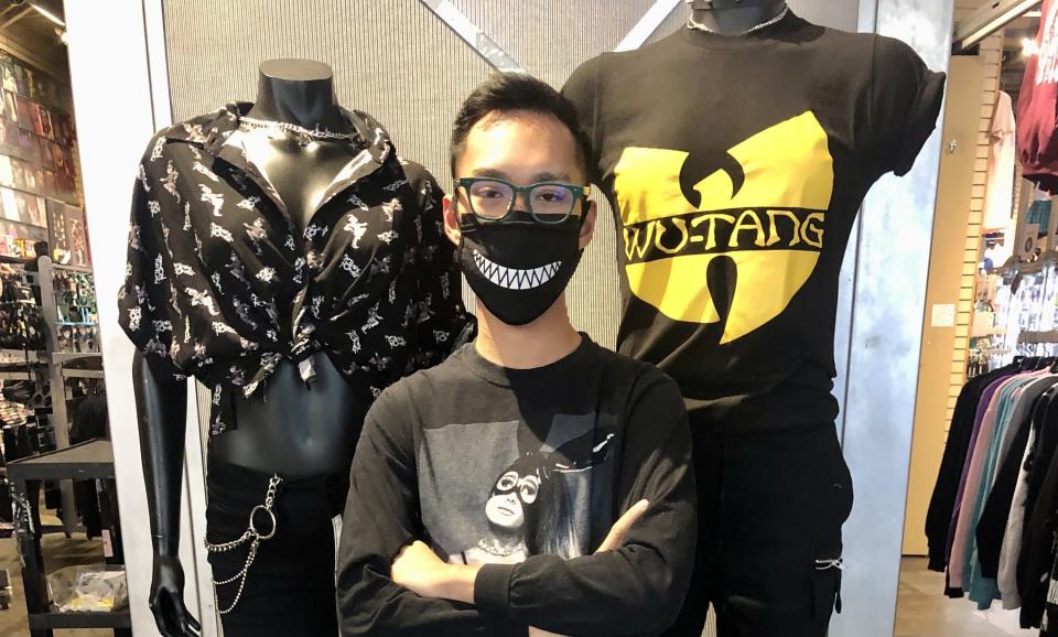 Author posing with mannequins wearing My Chemical Romance and Wu-Tang shirts