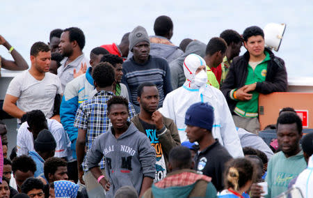 FILE PHOTO: Migrants wait to disembark the Italian coast guard vessel "Diciotti" in the port of Catania, Italy, June 13, 2018. REUTERS/Antonio Parrinello/File Photo