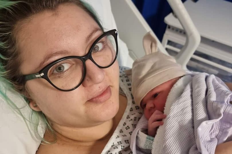 A new mum in a hospital bed with her baby