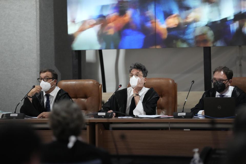 Judge Paolo Lepri, center, gestures during the first hearing of the trial for the Morandi bridge collapse at the Genoa's Palace of Justice Thursday, July 7, 2022. Forty-three people were killed when a large stretch of the Morandi Bridge broke off, August 14, 2018, on the eve of one of Italy's biggest vacation holidays. (AP Photo/Antonio Calanni)