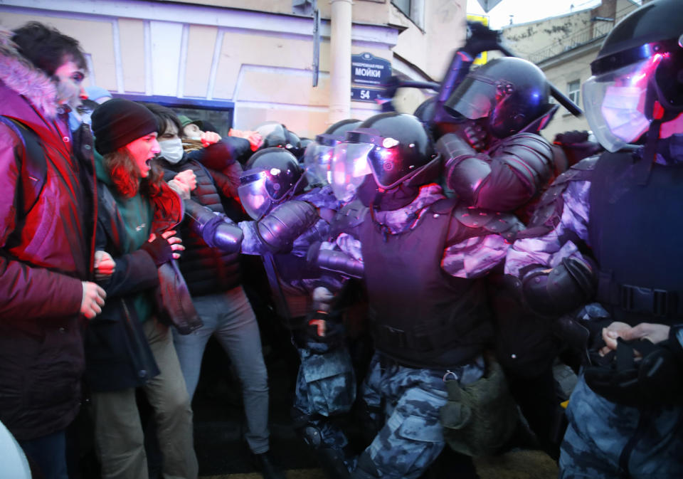 People clash with police during a protest in support of jailed opposition leader Alexei Navalny in St. Petersburg, Russia, Wednesday, April 21, 2021. A human rights group that monitors political repression said at least 400 people were arrested across the country in connection with the protests. Many were seized before protests even began, including two top Navalny associates in Moscow. (AP Photo/Dmitri Lovetsky)