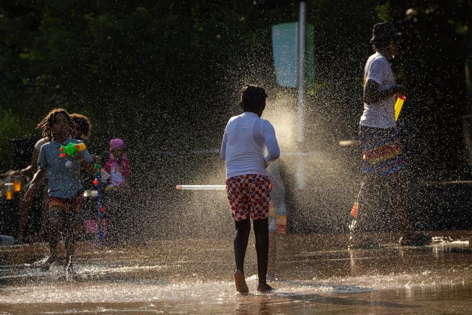 PHOTO: Children play with water guns at a splash pad at LeFrak Center at Lakeside at Prospect Park in Brooklyn, New York, June 20, 2024.  (Yuki Iwamura/AFP via Getty Images)