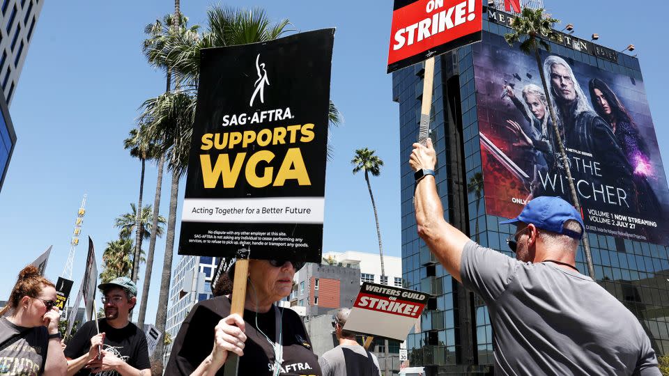 Member's of the actor's union SAG-AFTRA walk the picket line in solidarity with striking WGA (Writers Guild of America) workers outside Netflix offices in Los Angeles, California. - Mario Tama/Getty Images