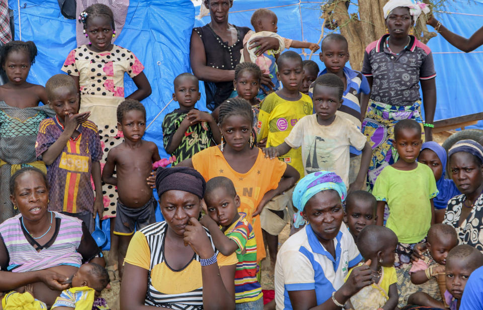 Women and children sit outside their tents in a makeshift site for displaced people in Kongoussi, Burkina Faso, Thursday, June 4, 2020. Jihadist violence has dramatically escalated in Burkina Faso in recent years. The country's military has struggled to contain the violence. (AP Photo/Sam Mednick)