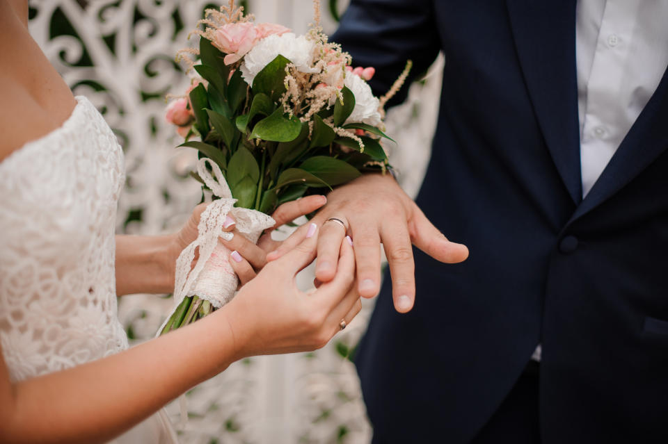 A bride and groom exchanging rings