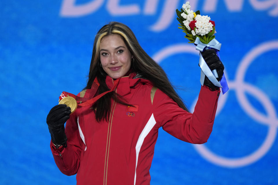 FILE - Gold medalist China's Eileen Gu poses during a medal ceremony for the women's freestyle skiing halfpipe competition at the 2022 Winter Olympics, Friday, Feb. 18, 2022, in Zhangjiakou, China. Two years after exploding onto the world stage at the Beijing Winter Games, the 20-year-old Olympic champion, straight-A student and fashion model remains as comfortable on a catwalk as a halfpipe. She finds as much joy in defying classical physics on the mountain in Aspen as exploring quantum physics in the classroom at Stanford. (AP Photo/Alessandra Tarantino, File)