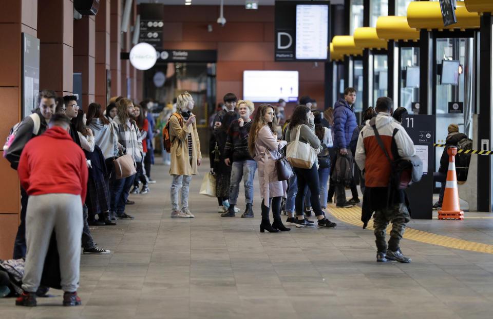 Commuters wait for transport at a bus interchange in Christchurch, New Zealand, Monday, June 8, 2020. New Zealand appears to have completely eradicated the coronavirus, at least for now, after health officials said Monday the last known infected person had recovered. (AP Photo/Mark Baker)