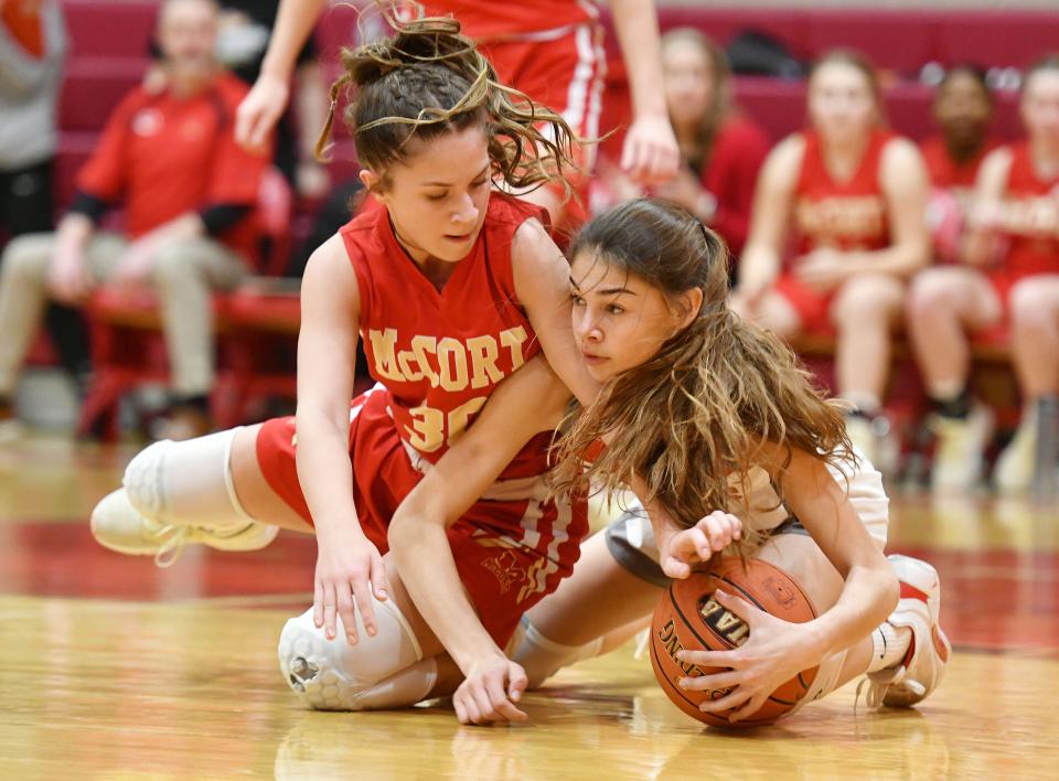 Freedom's Riley Tokar and Bishop McCort's Elle Berkebile fight for a loose ball during Friday night's PIAA Class 2A playoff game at Freedom High School.