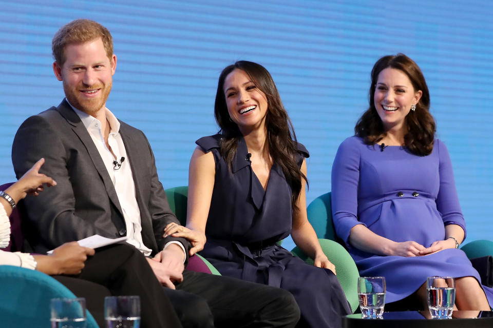 Prince Harry and Kate Middleton flank Meghan Markle, in a navy trench coat, at the first annual Royal Foundation Forum held at Aviva on Feb. 28, 2018, in London. (Photo: Chris Jackson – WPA Pool/Getty Images)