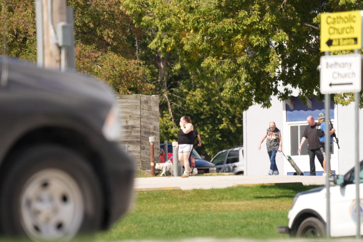 Evacuees are lead way from the Budget Inn & Suites on Tuesday, Sept. 26, 2023 after a suspect barricaded himself in the north Des Moines hotel.