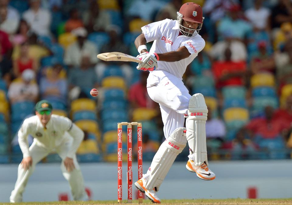 West Indies batsman Darren Bravo (R) plays a shot off Australian bowler Ben Hilfenhaus during the fourth day of the first-of-three Test matches between Australia and West Indies at the Kensington Oval stadium in Bridgetown on April 10, 2012. Hilfenhaus took three wickets as play continues. AFP PHOTO/Jewel Samad (Photo credit should read JEWEL SAMAD/AFP/Getty Images)