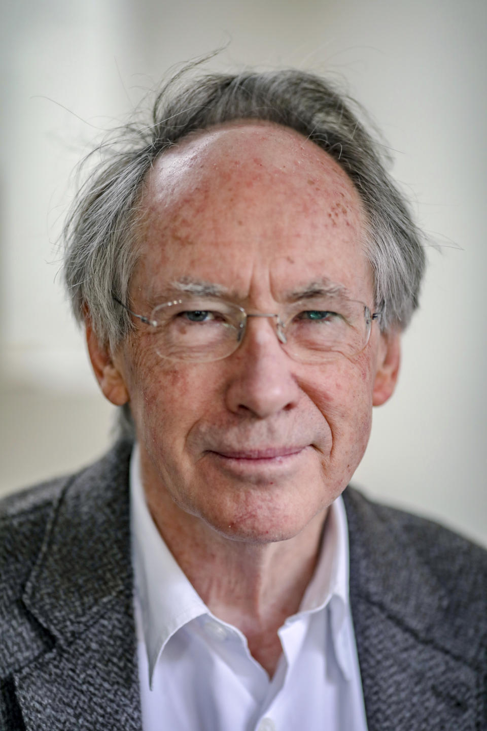 In this photo taken on Thursday, April 18, 2019, Booker Prize award winning English novelist and screenwriter Ian Russell McEwan talks to Associated Press about his new novel "Machines Like Me" in London. McEwan is fascinated by artificial intelligence. A central character in his new novel is a lifelike android with access to all human knowledge who writes haiku poetry. The book, published in the United States Tuesday, April 23 by Doubleday, looks at the messy relationship between human minds and artificial ones. (AP Photo/Vudi Xhymshiti)