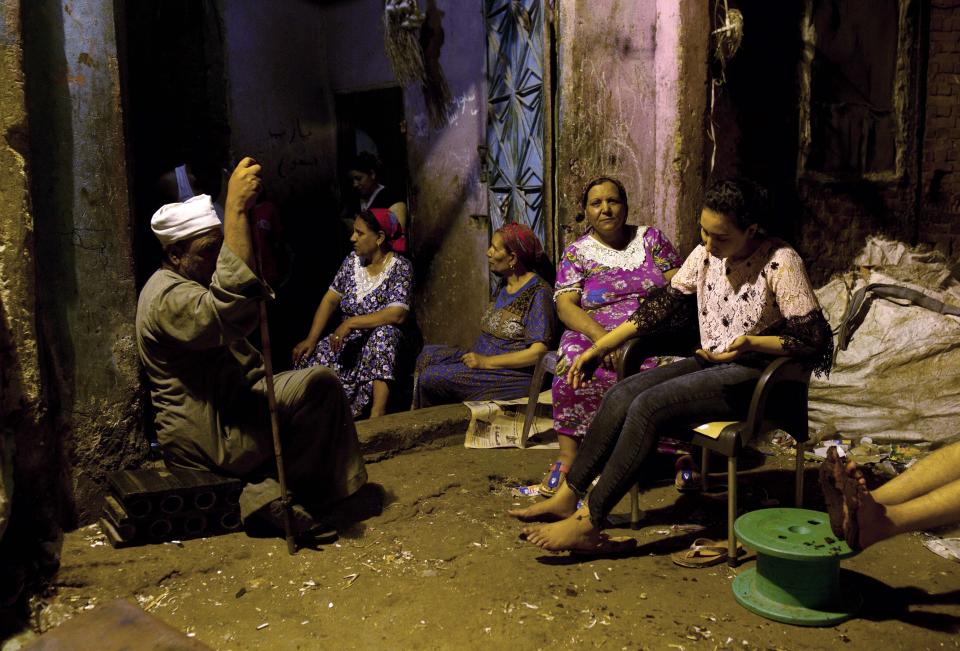 In this June 15, 2019 photo, a young woman waits for henna to dry on the soles of her feet, a tradition for brides the night before their wedding, at her family home in the Manshiyat Nasser area of Cairo, Egypt. Egypt’s legal system grants the Coptic church full authority over personal status matters of Copts, namely marriage and divorce. But the church does not have the same powers over its followers’ inheritance rights. (AP Photo/Maya Alleruzzo)
