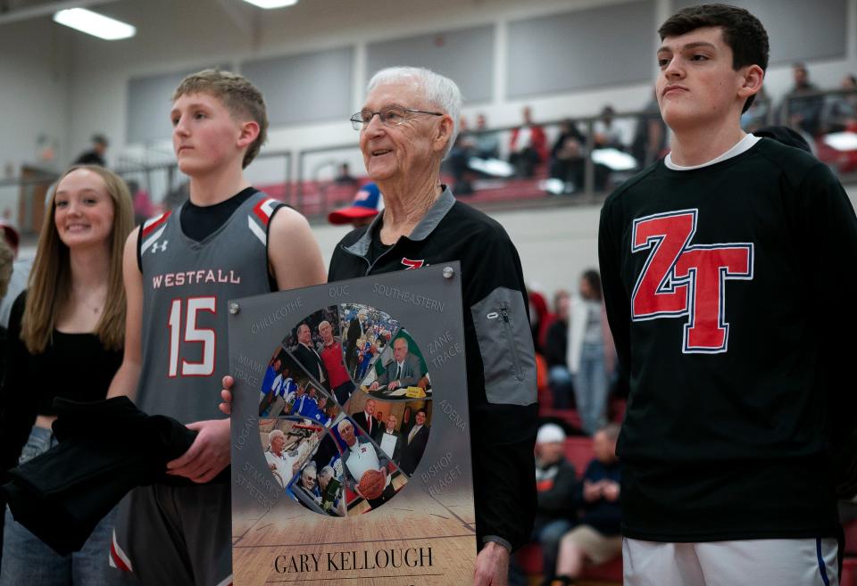 Zane Trace boys varsity head basketball coach Gary Kellough receives a plaque during a celebration held in his honor of coaching high school basketball for the last 52 years, mostly in the Chillicothe and Ross county areas, at Zane Trace High School on Feb. 13, 2024, in Chillicothe, Ohio.