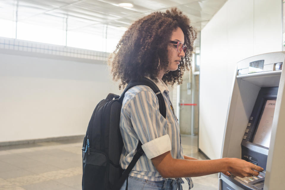 Young person using an ATM