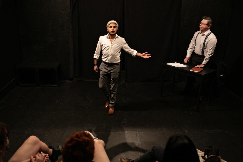 Two people perform a scene for class.