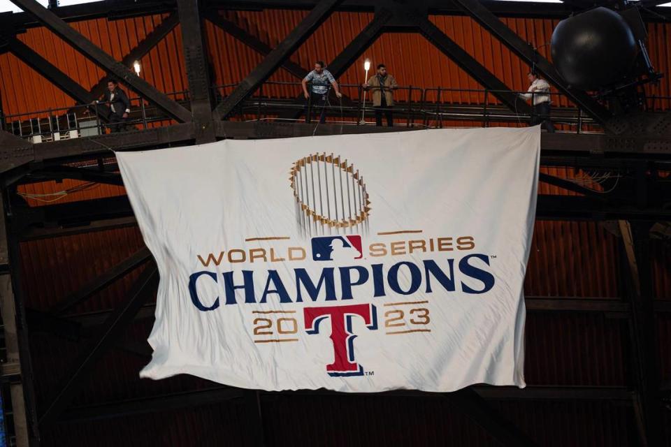 The Texas Rangers 2023 World Series Banner is unveiled in a ceremony prior to their season opener against the Chicago Cubs at Globe Life Field on Thursday, March 28, 2024. Chris Torres/ctorres@star-telegram.com