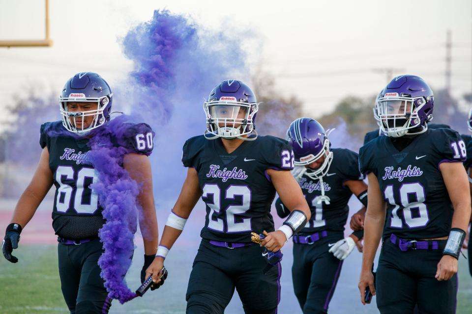 Shadow Hills football players Ericson Soto (60), Jason Diaz (22) and Jermiah Peffers (18) enter the field before their win against Citrus Hill in Indio, Calif., on August 26, 2022. 
