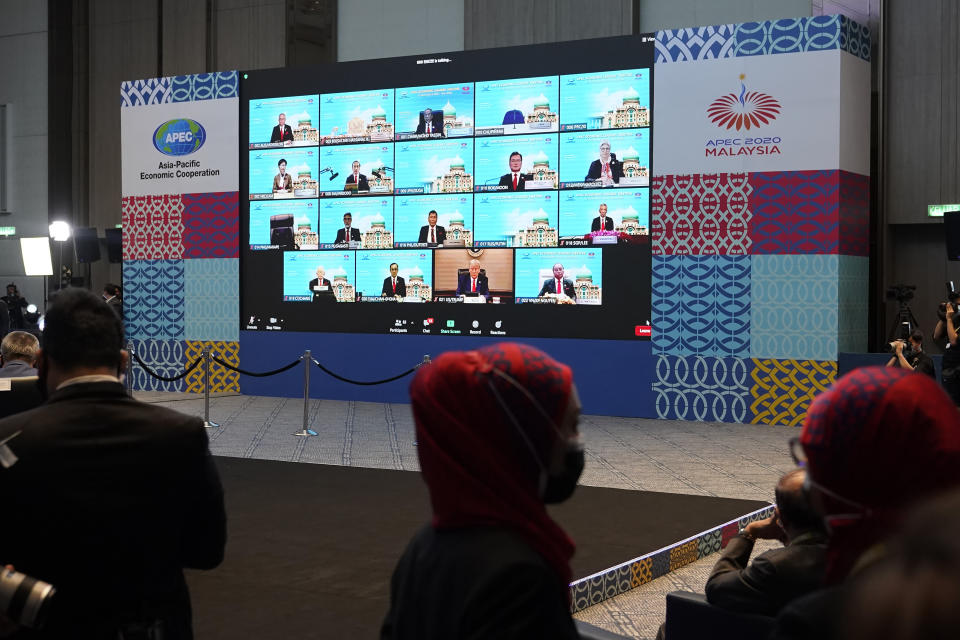 Monitors showing the opening leaders attending the first virtual Asia-Pacific Economic Cooperation (APEC) leaders' summit, hosted by Malaysia, in Kuala Lumpur, Malaysia, Friday, Nov. 20, 2020. (AP Photo/Vincent Thian)