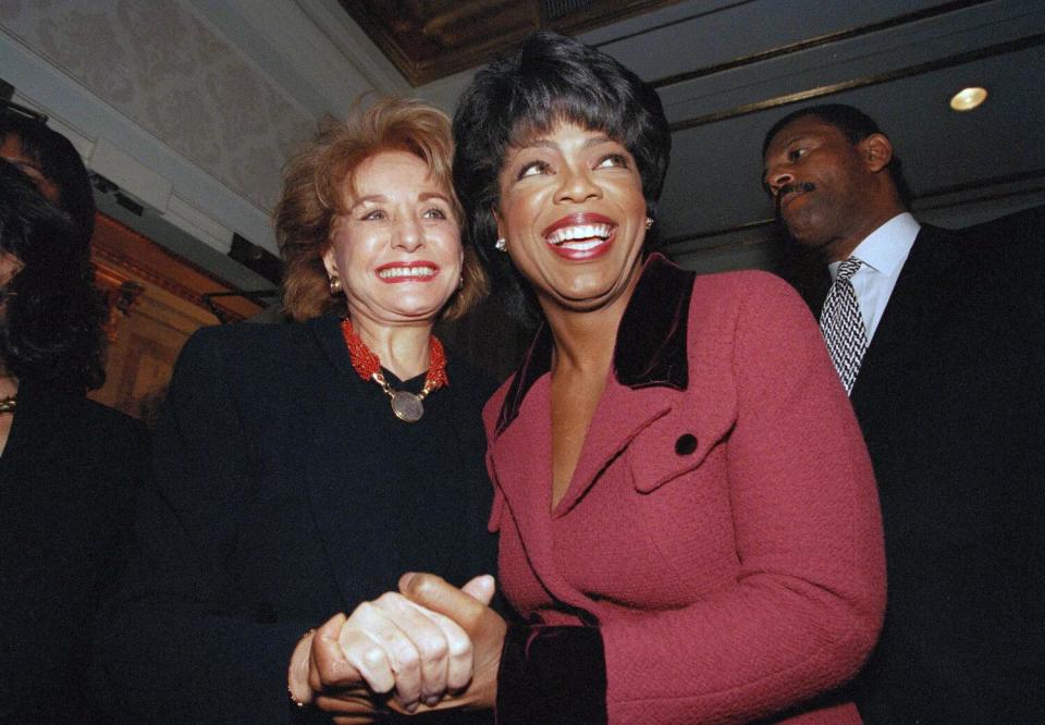 Oprah Winfrey is greeted by Barbara Walters at New York's Plaza Hotel