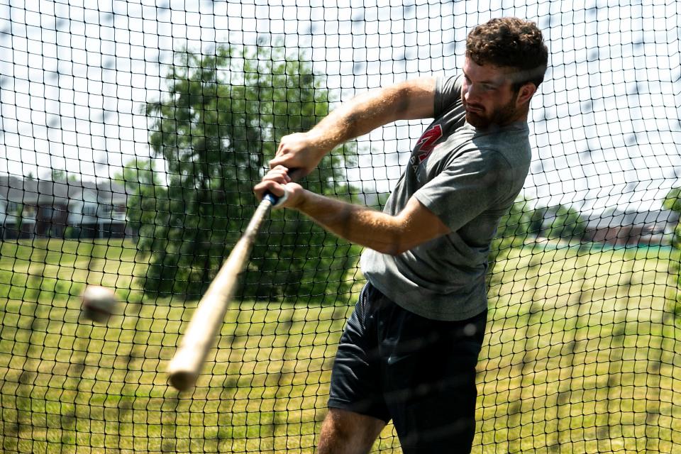 Western Dubuque alum Calvin Harris takes some swings in the family's batting cage on June 19 in Peosta.